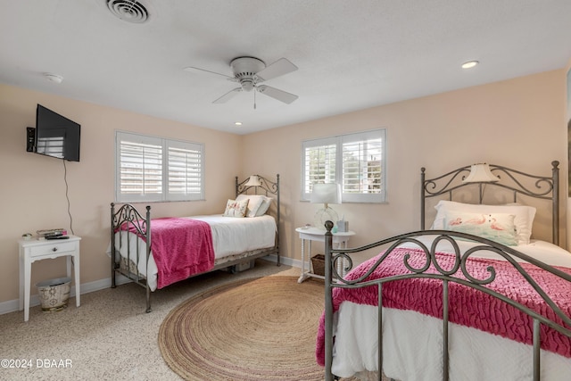 bedroom featuring multiple windows and ceiling fan