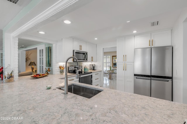 kitchen featuring sink, white cabinetry, and stainless steel appliances