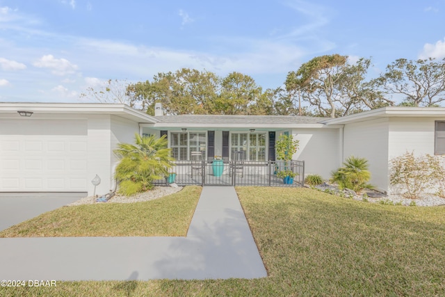 view of front of house with a garage, covered porch, and a front lawn