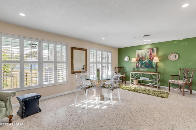 dining space featuring a textured ceiling