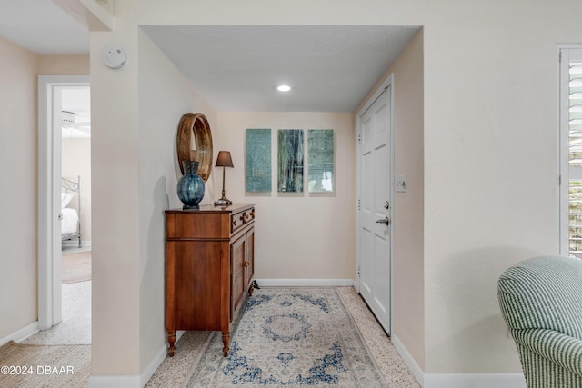 doorway featuring a textured ceiling and a wealth of natural light