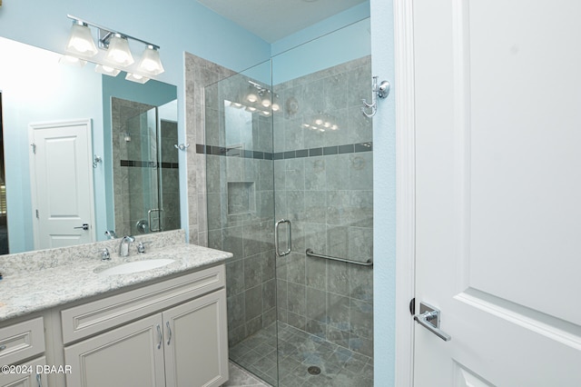 bathroom featuring vanity and a shower with shower door