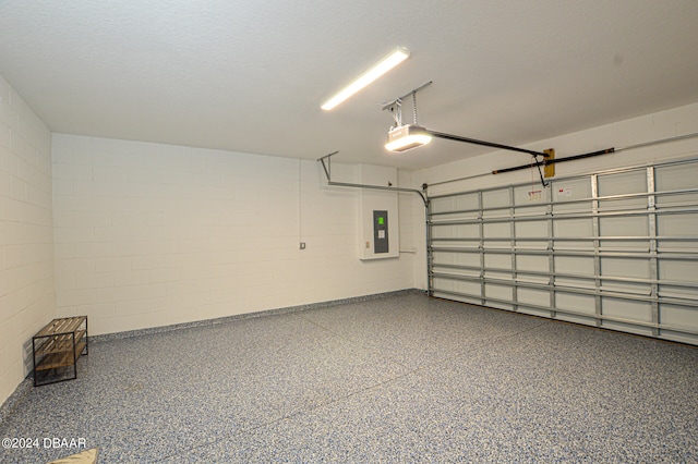 garage with a garage door opener and electric panel