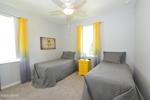 bedroom with ceiling fan and light colored carpet