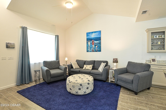 living room featuring light wood-type flooring, lofted ceiling, and ceiling fan