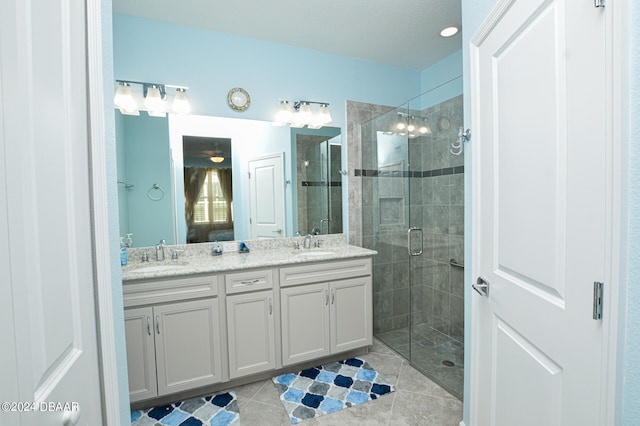 bathroom with tile patterned flooring, an enclosed shower, and vanity