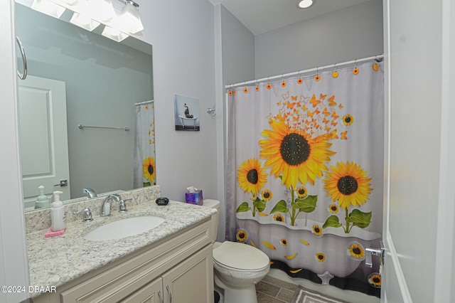 bathroom featuring vanity, tile patterned floors, toilet, and a skylight