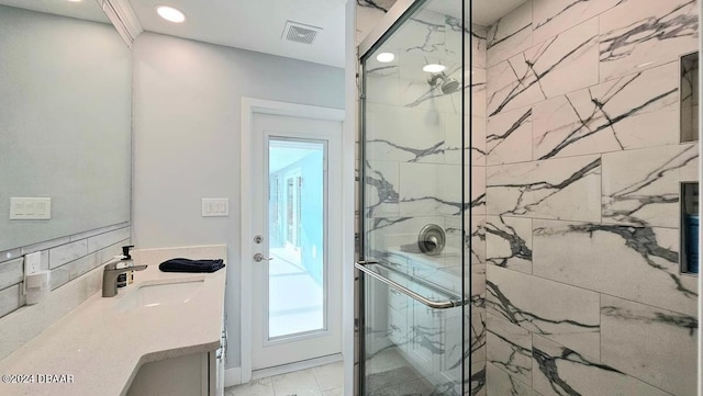 bathroom featuring walk in shower and vanity