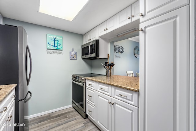 kitchen featuring white cabinetry, light hardwood / wood-style floors, and appliances with stainless steel finishes