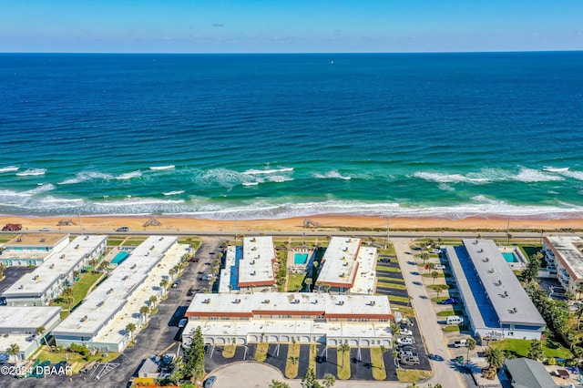 aerial view with a water view and a beach view