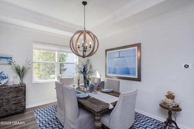 dining area featuring dark hardwood / wood-style floors, ornamental molding, and an inviting chandelier