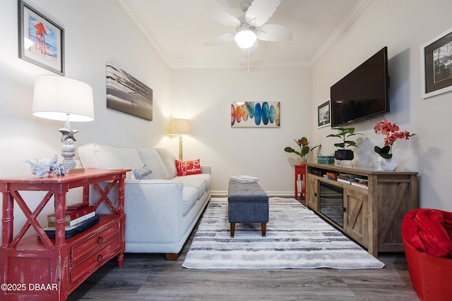 living room with dark wood-type flooring, crown molding, and ceiling fan