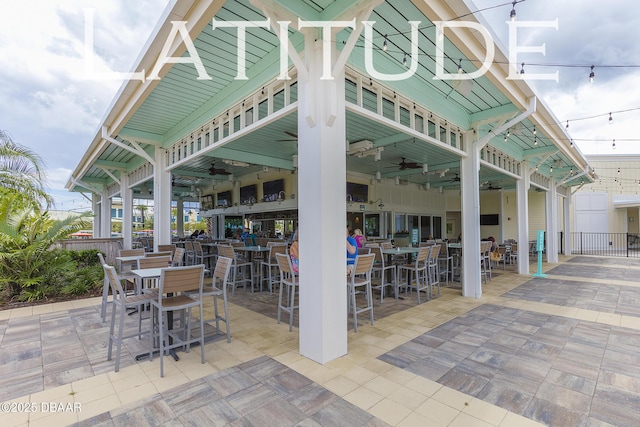 view of patio / terrace with ceiling fan and an outdoor bar