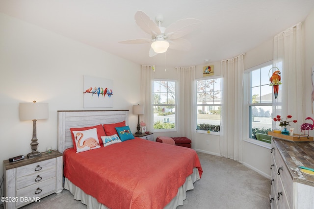 bedroom featuring ceiling fan and light colored carpet