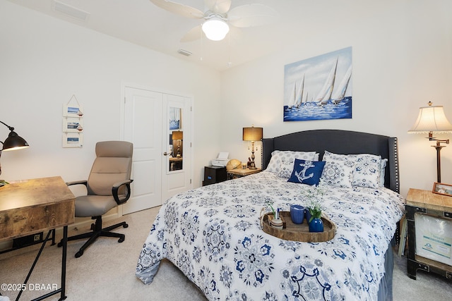 carpeted bedroom with ceiling fan and a closet