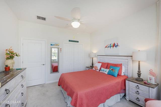 bedroom featuring ceiling fan, a closet, and light carpet