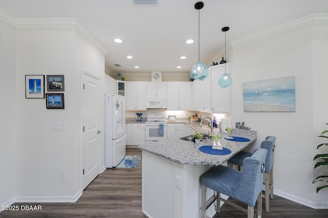 kitchen featuring white cabinetry, white appliances, ornamental molding, a breakfast bar, and sink