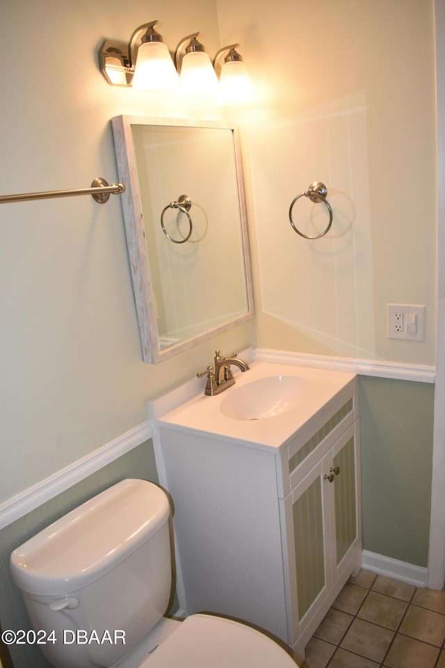 bathroom with tile patterned flooring, vanity, and toilet