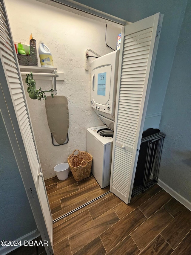 clothes washing area featuring stacked washer and clothes dryer