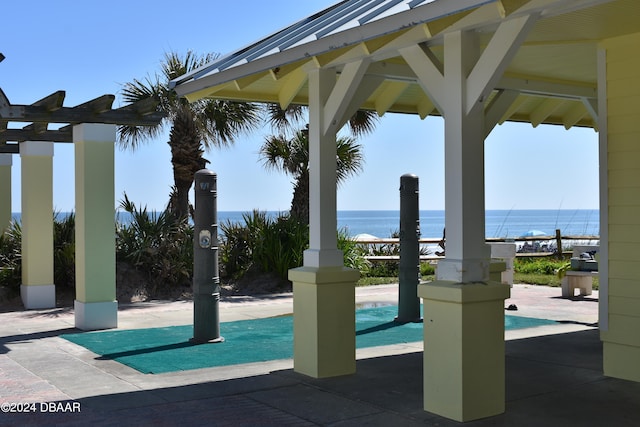 view of swimming pool with a gazebo and a water view