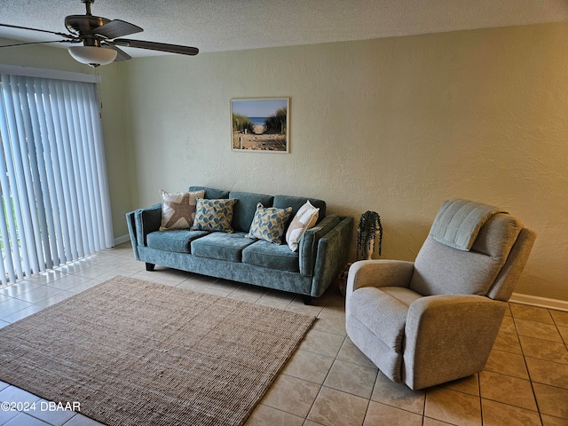 tiled living room with a textured ceiling and ceiling fan