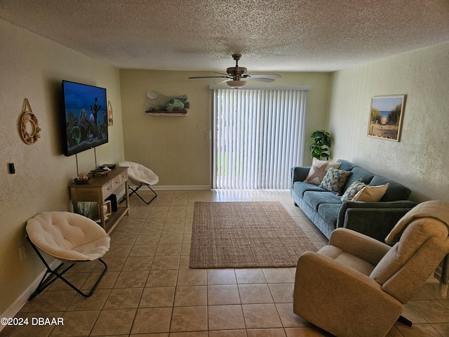 tiled living room with ceiling fan and a textured ceiling