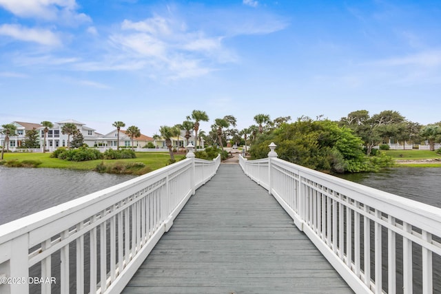 dock area featuring a water view and a residential view