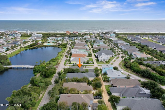 birds eye view of property featuring a water view and a residential view