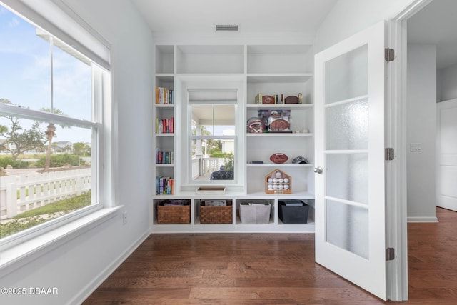 mudroom featuring visible vents, built in features, baseboards, and dark wood-style floors