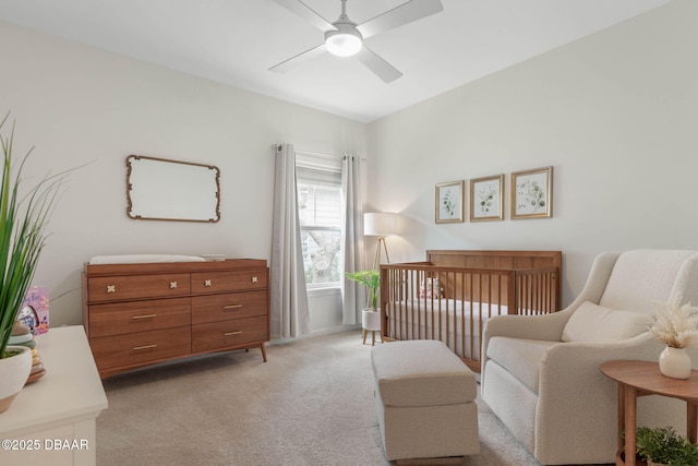 bedroom with a nursery area, ceiling fan, light carpet, and lofted ceiling