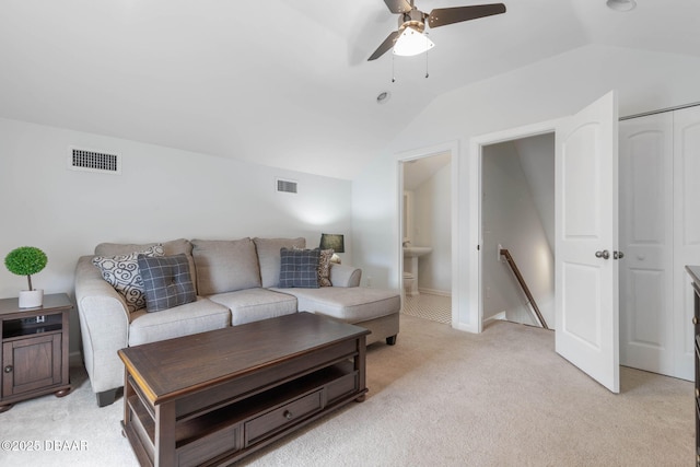 living room featuring a ceiling fan, vaulted ceiling, light carpet, and visible vents