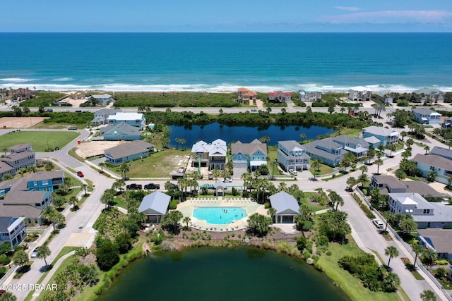 drone / aerial view featuring a water view and a residential view