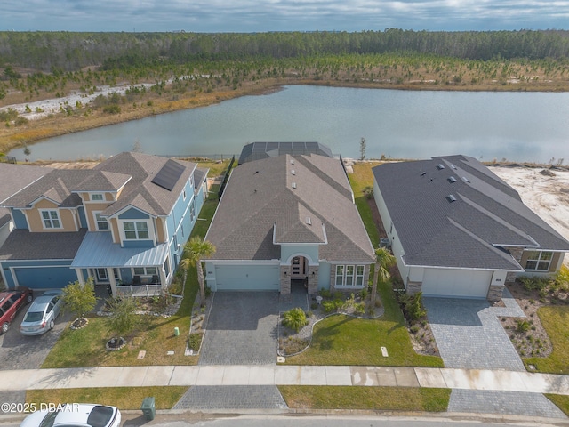 bird's eye view with a view of trees, a water view, and a residential view