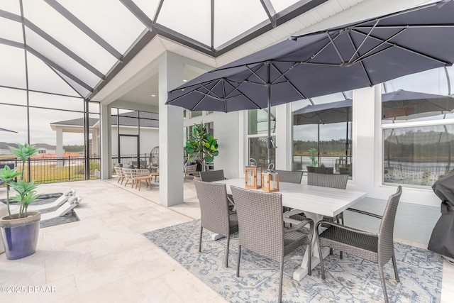 view of patio with a lanai and outdoor dining space