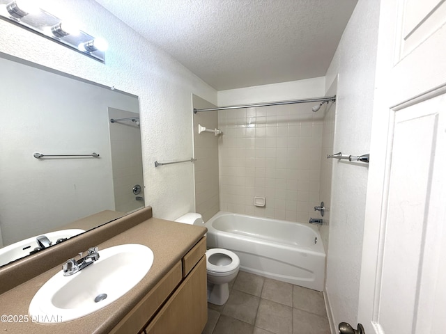 bathroom featuring a textured wall, toilet, a textured ceiling, vanity, and tile patterned flooring