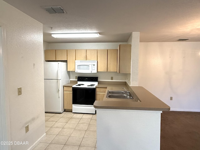 kitchen with white appliances, visible vents, a sink, and light brown cabinetry