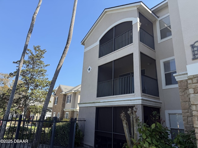 view of building exterior with fence