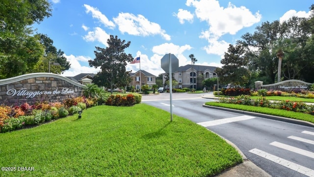 view of street featuring a residential view and curbs