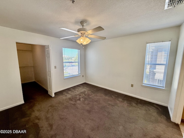 unfurnished bedroom with carpet floors, baseboards, visible vents, and a textured ceiling