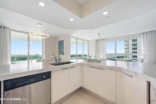241 Riverside Dr Unit 2301, Holly Hill, FL 32117 - kitchen with recessed lighting, a sink, light tile patterned floors, stainless steel dishwasher, and white cabinets