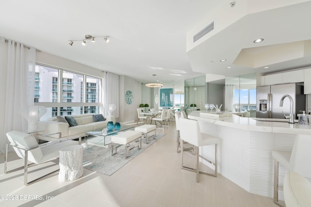 241 Riverside Dr Unit 2301, Holly Hill, FL 32117 - living room featuring visible vents and a healthy amount of sunlight