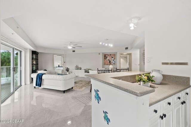 kitchen featuring white cabinets and ceiling fan