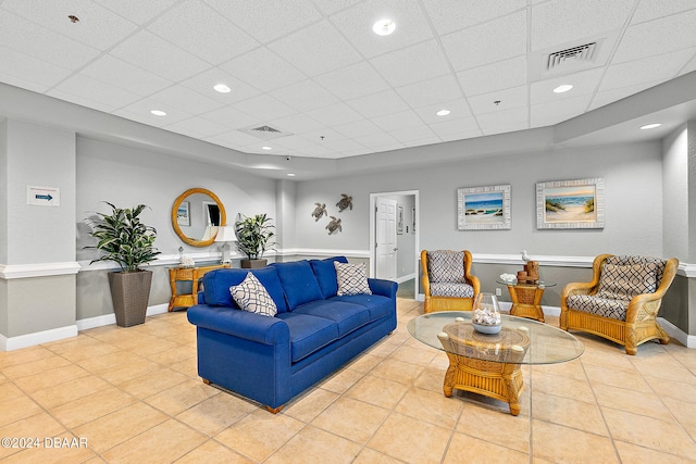 tiled living room with a paneled ceiling