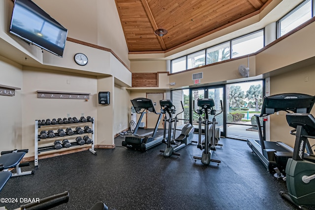 workout area with a high ceiling and wooden ceiling