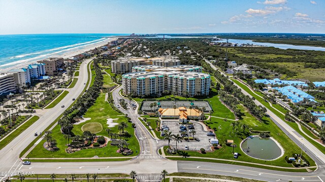 drone / aerial view featuring a water view and a beach view