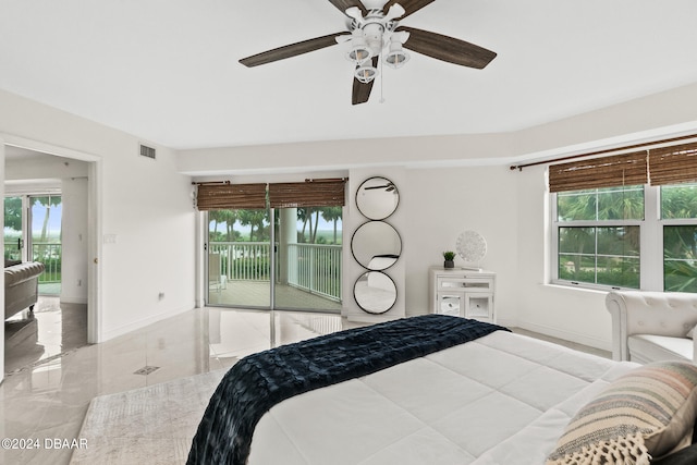 bedroom with access to exterior, multiple windows, and ceiling fan