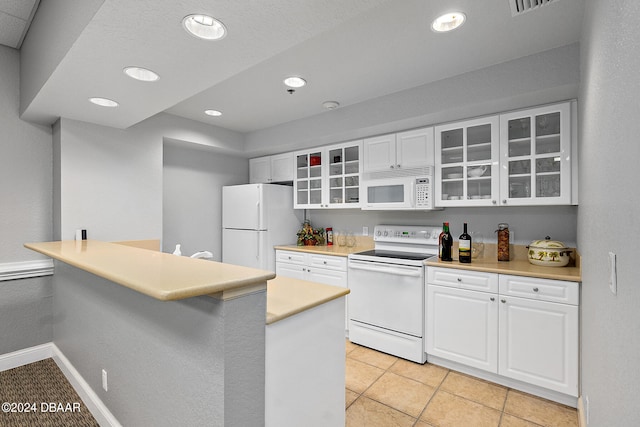 kitchen featuring white cabinets, white appliances, light tile patterned floors, and kitchen peninsula