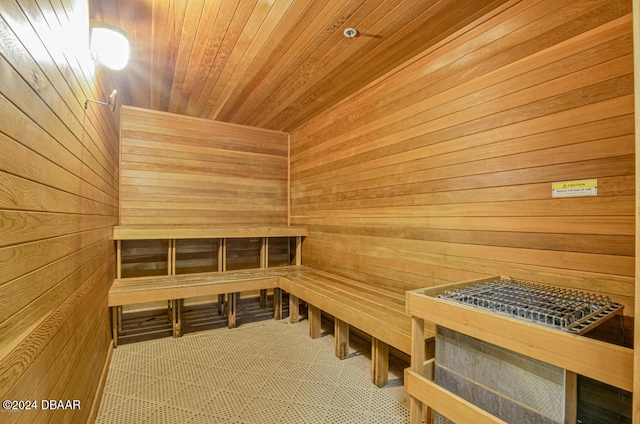 view of sauna / steam room featuring wooden walls and wood ceiling