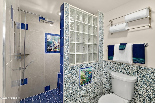 full bathroom with toilet, tile walls, and a walk in shower