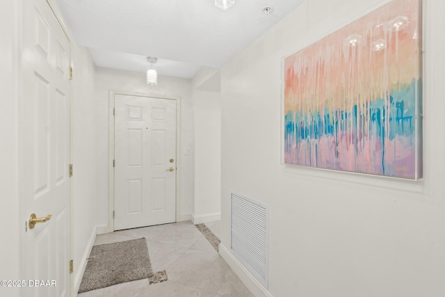 entryway featuring tile patterned flooring, visible vents, and baseboards